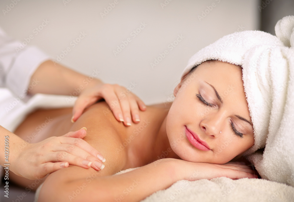 An attractive woman getting spa treatment, isolated on white