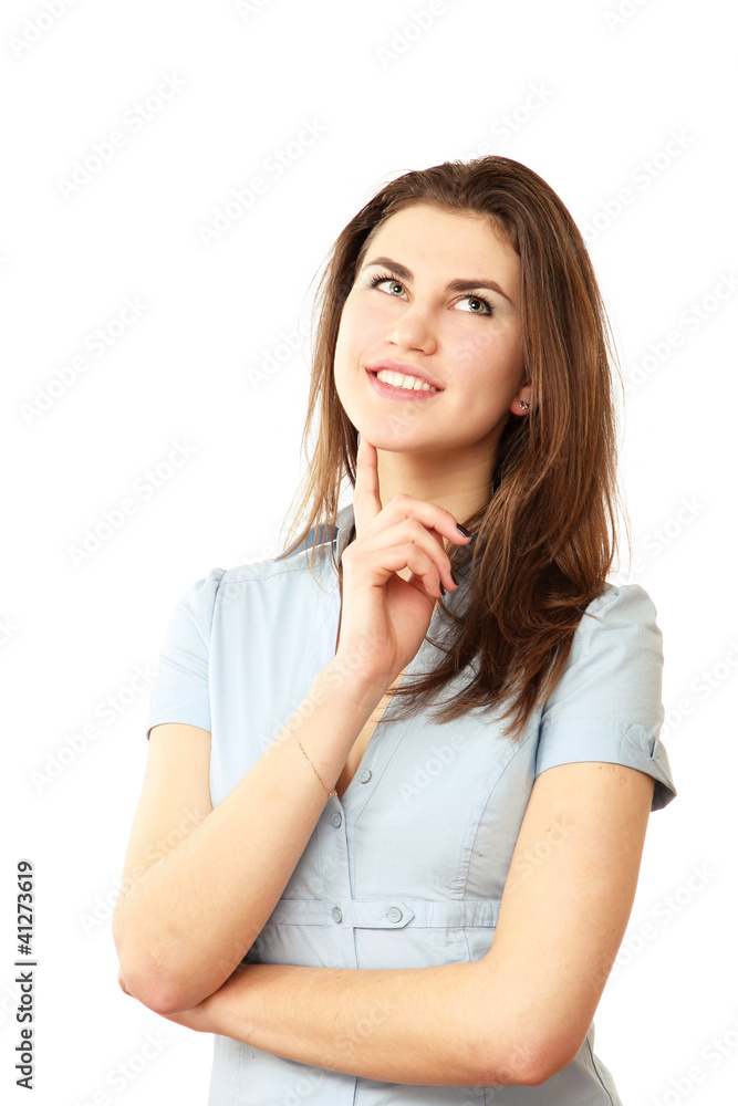 A smiling woman looking up, touching her face A smiling woman looking up, touching her face