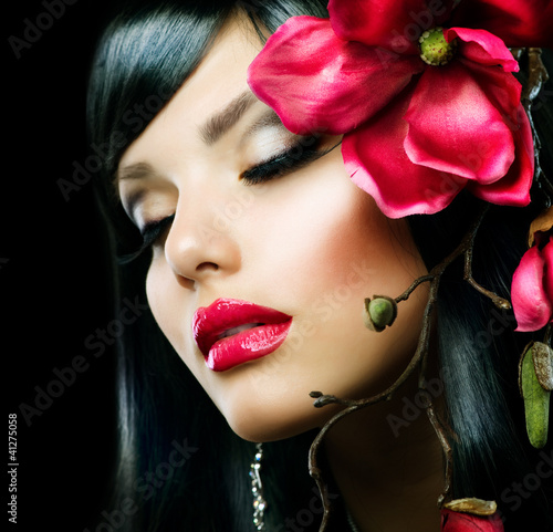 Fashion Brunette Girl with Magnolia Flower isolated on Black #41275058