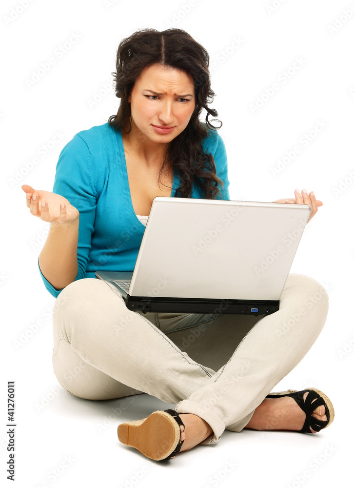 Young colledge girl sitting on the floor with a laptop Young colledge girl sitting on the floor with a laptop