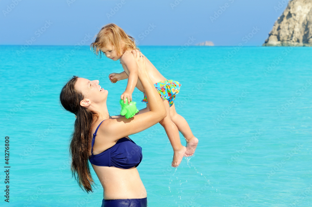 Happy child with her mother on the beach