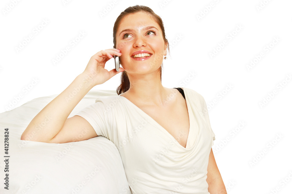 Beautiful happy woman on a white sofa making a phone call Beautiful happy woman on a white sofa making a phone call