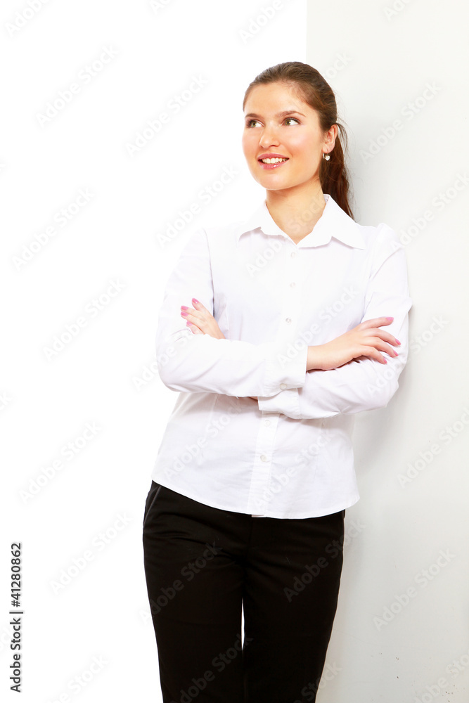 A businesswoman standing near the wall, isolated on white A businesswoman standing near the wall, isolated on white