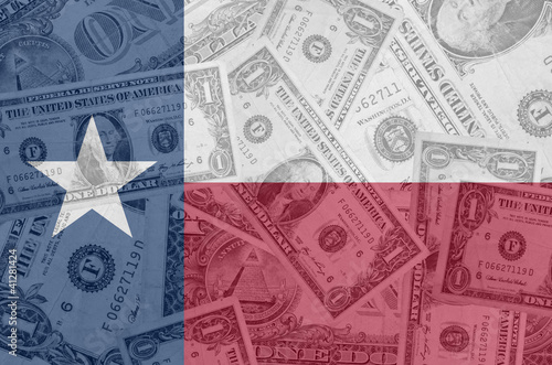 US state of texas flag with transparent dollar banknotes in back