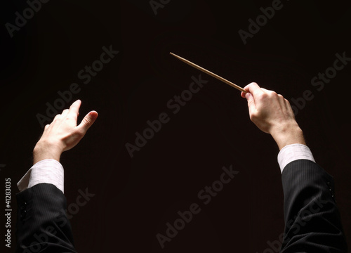 Concert conductor's hands with a baton