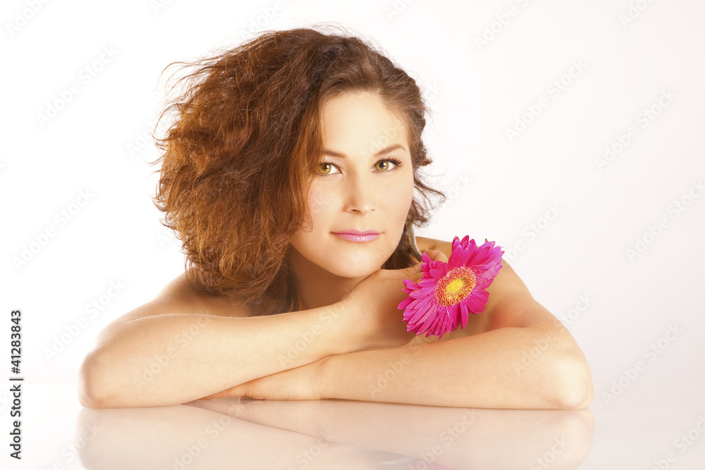 Girl with a flower and luxurious brown hair