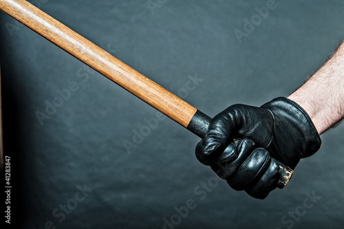 black leather glove and a stick