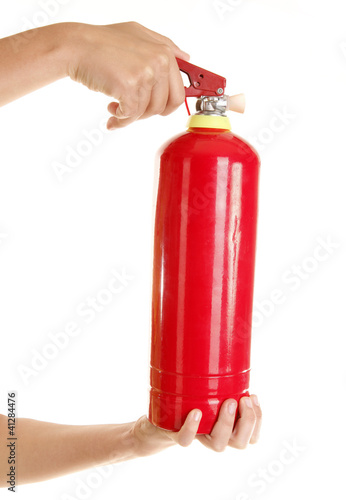 Hands are holding red fire extinguisher