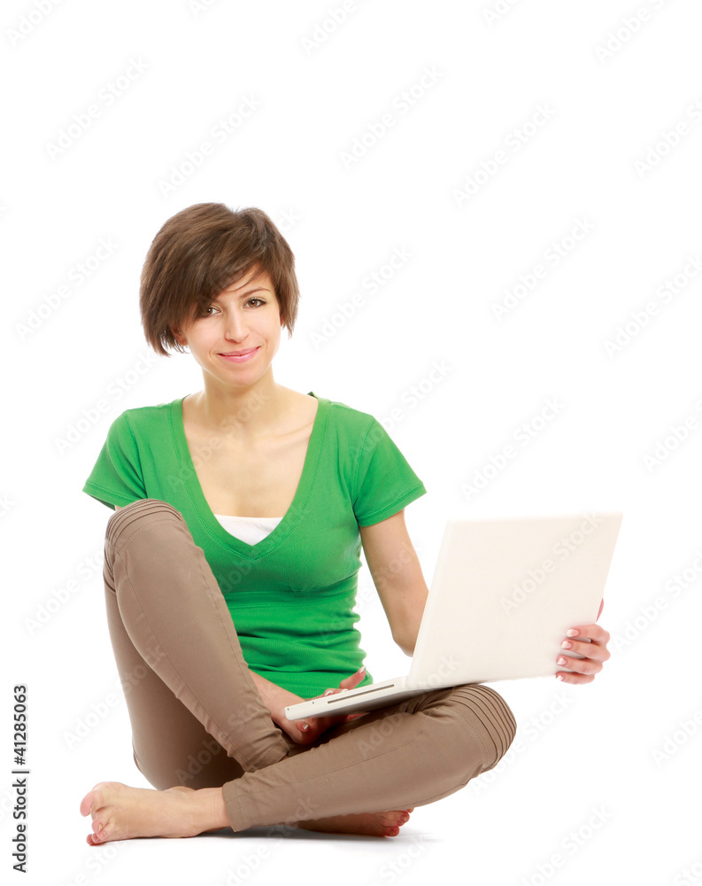 A young college girl with a laptop, sitting on the floor