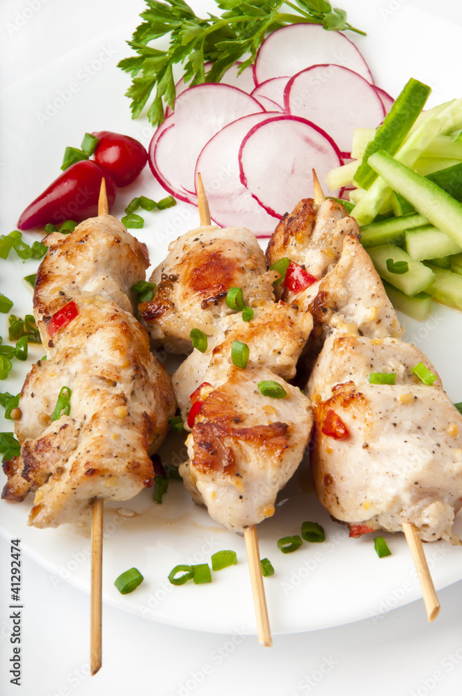 barbecue chicken on a white plate with vegetables barbecue chicken on a white plate with vegetables