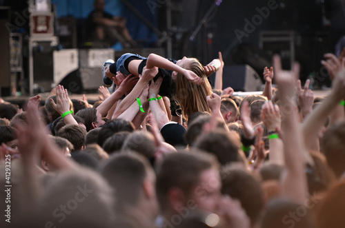 The crowd carrying the young woman during concert