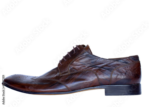 Single brown leather shoe isolated on white