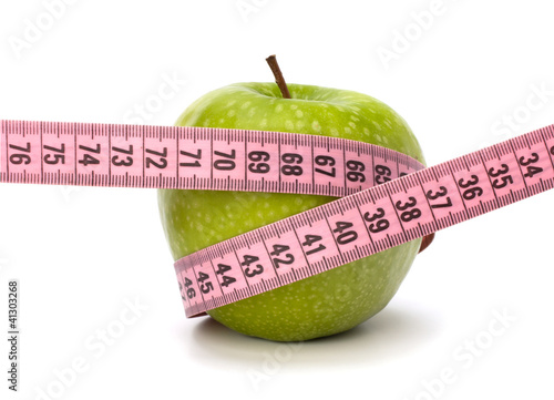 Apple with tape measure. Healthy lifestyle concept. photo