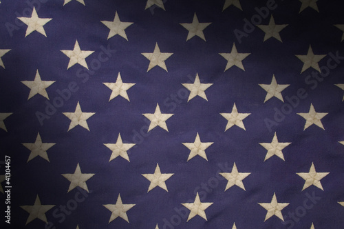 Stars in a field of blue on an American flag lit diagonally