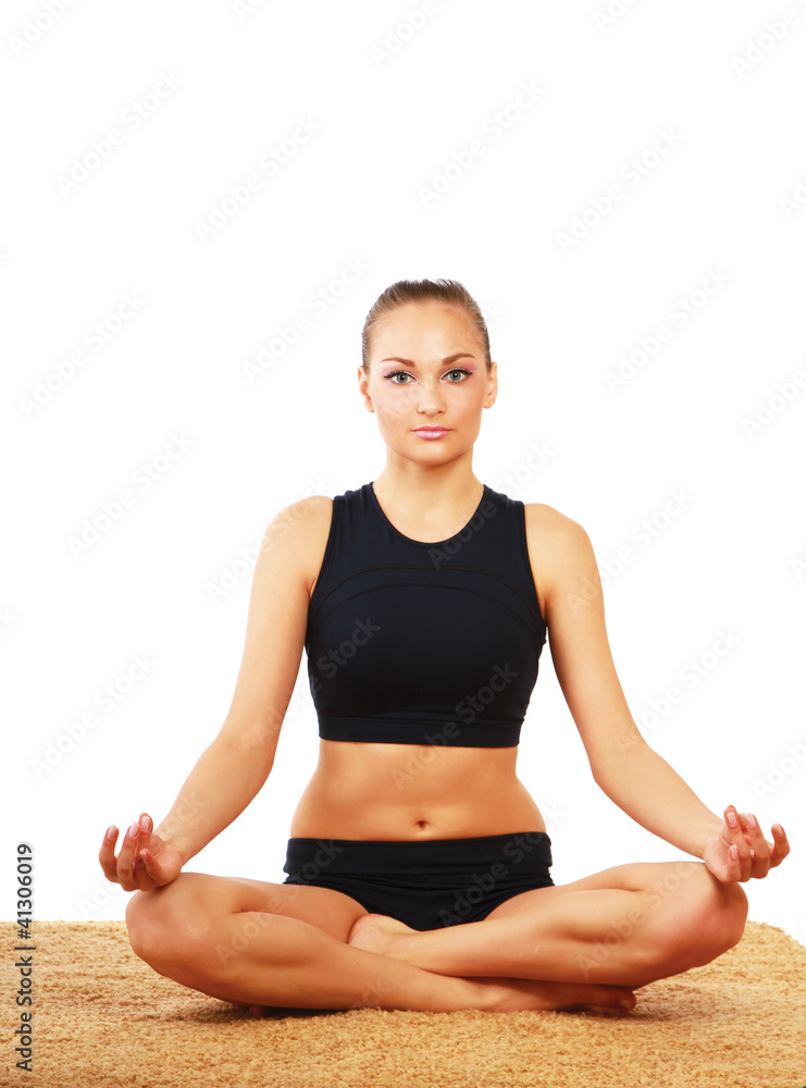 A young woman doing yoga, isolated on white background