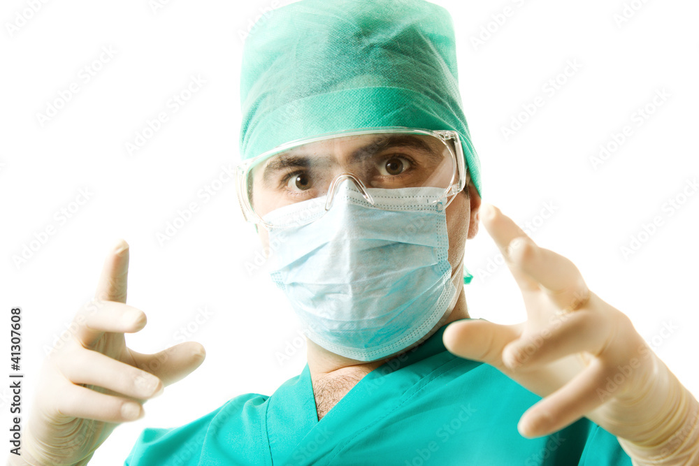 Male surgeon wearing a mask and gloves Male surgeon wearing a mask and gloves
