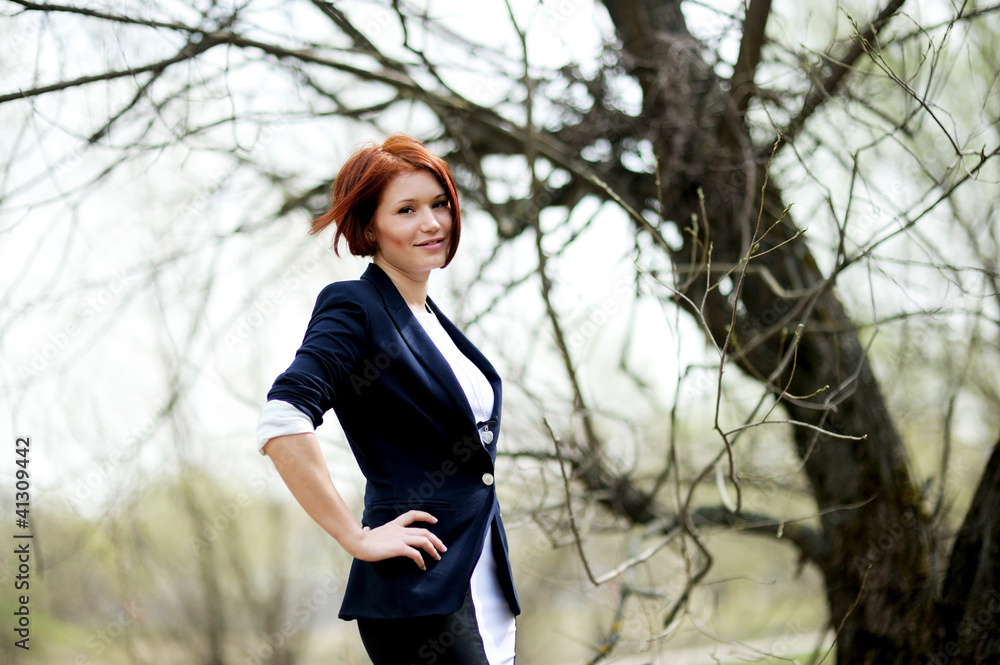 Beautiful woman with red hair posing outdoors Beautiful woman with red hair posing outdoors