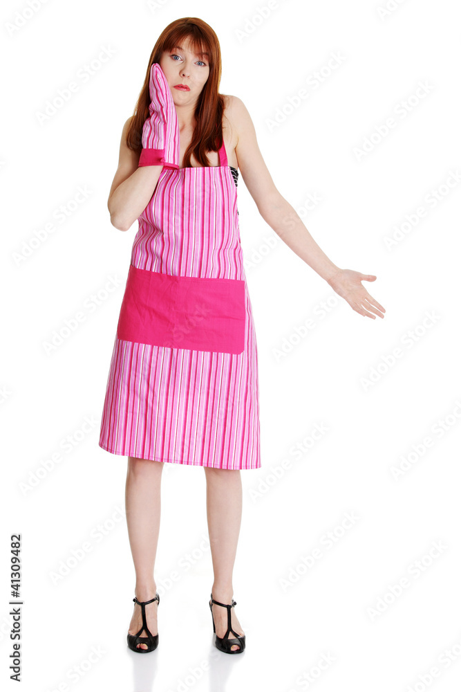 Young troubled housewife in pink apron