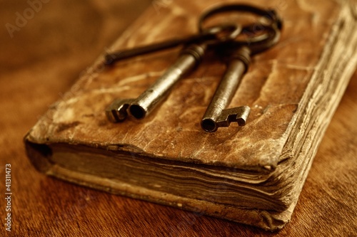 Old metal keys on vintage book. photo