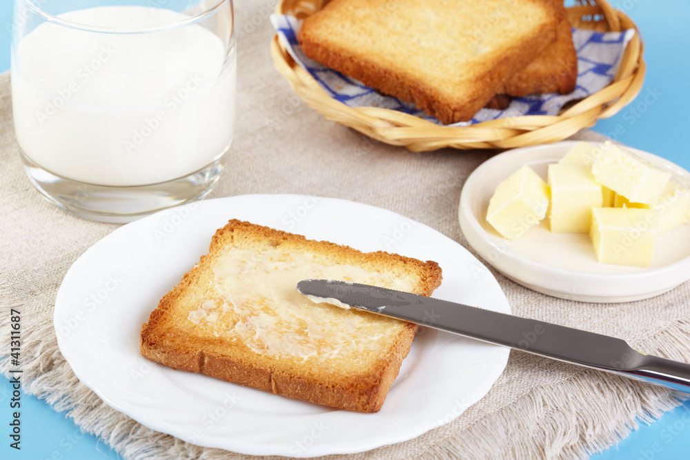 Breakfast. Glass with milk and toasts with butter Breakfast. Glass with milk and toasts with butter