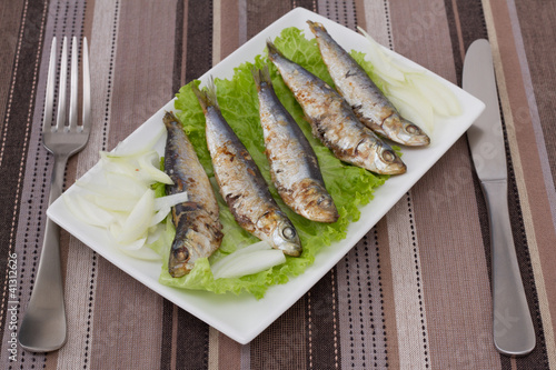 fried sardines on lettuce
