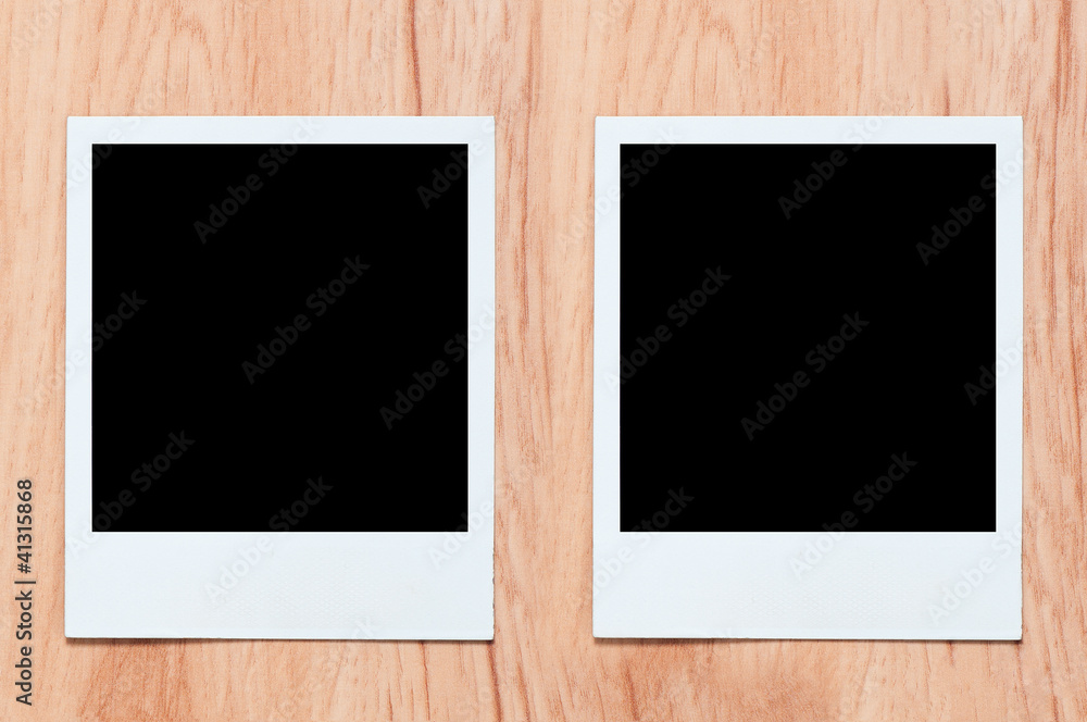 two old, blank picture on table. picture on wooden background two old, blank picture on table. picture on wooden background