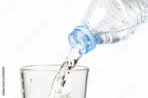 Clean water flowing into the bottle. On a white background.