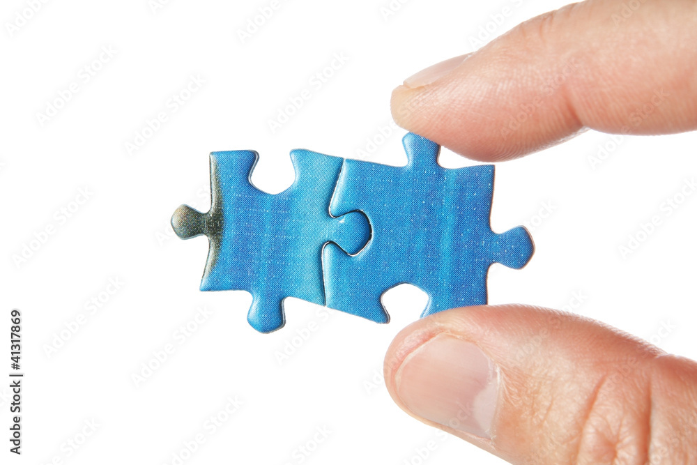 United two puzzle in the fingers. On a white background. United two puzzle in the fingers. On a white background.
