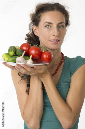 Portrait of a young beautiful woman with vegetables