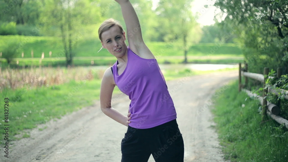 Young woman feeling pain in back during exercise Young woman feeling pain in back during exercise