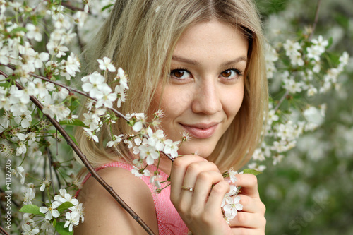 Portrait of beautiful blond in spring blossom