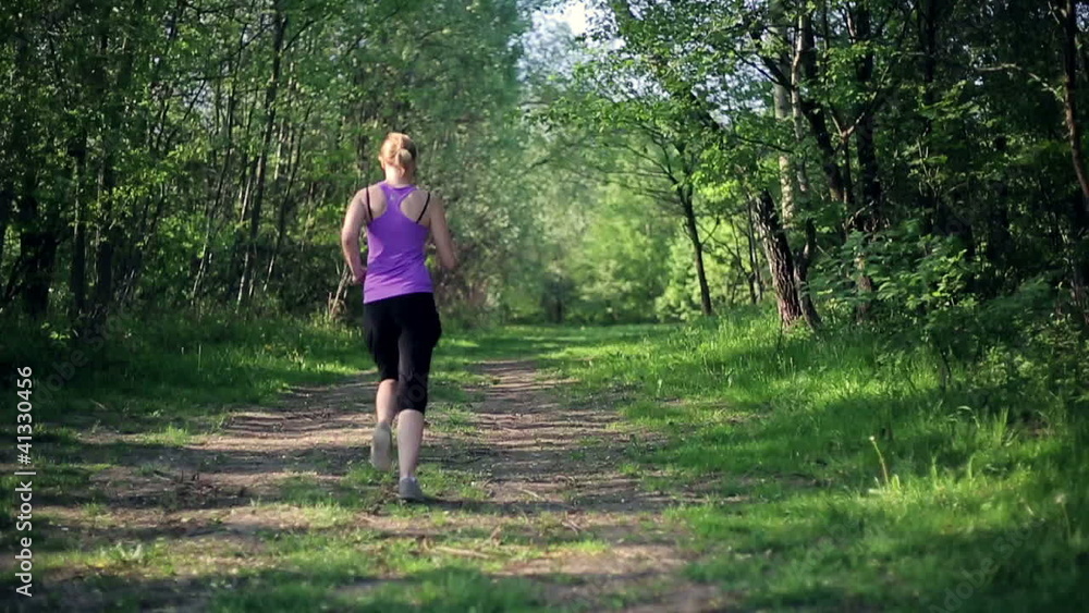 Two young women jogging on the forest track, slow motion Two young women jogging on the forest track, slow motion