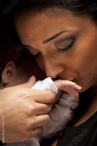 Ethnic Woman Kisses Her Newborn Baby Hand