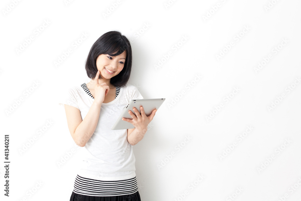 attractive asian woman using tablet computer attractive asian woman using tablet computer