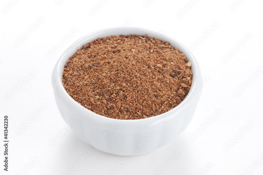 Nutmeg powder (Myristica fragrans) in a white bowl on white back Nutmeg powder (Myristica fragrans) in a white bowl on white back