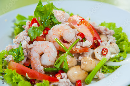 Thai dressed spicy salad with prawn, pork, green herbs and nuts