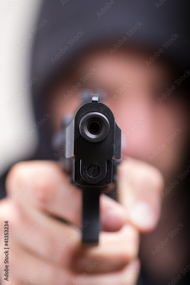 Man with gun, gangster, focus on the gun Man with gun, gangster, focus on the gun