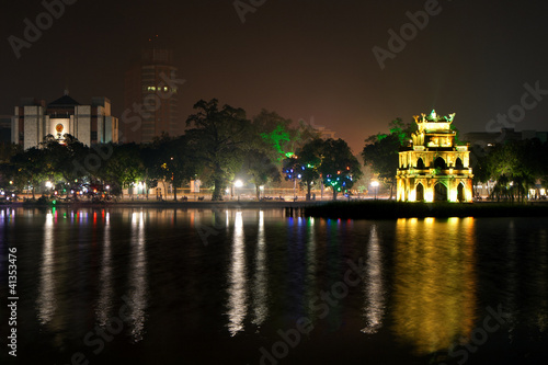 Reflection of lit Turtle Tower at Hoan Kiem Lake in Hanoi