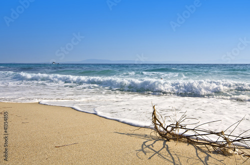 Sunny summer beach at the mediterranean coast in Greece