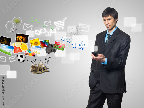 Businessman using touch screen mobile phone with streaming image