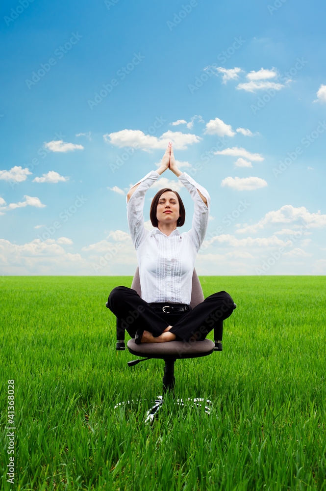young businesswoman practicing yoga on the meadow young businesswoman practicing yoga on the meadow