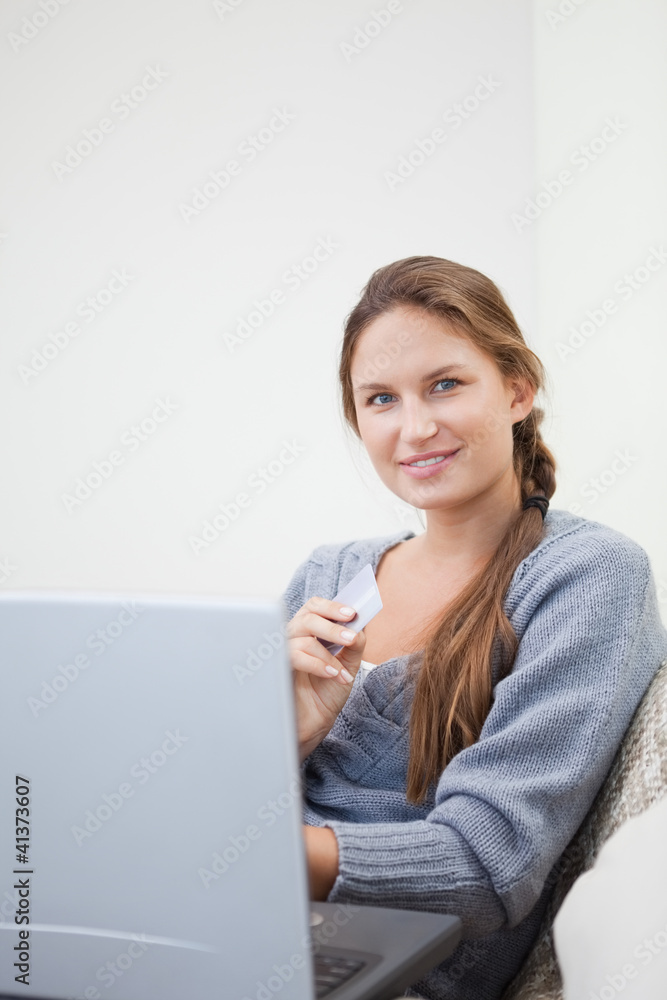 Woman sitting while using her tablet computer Woman sitting while using her tablet computer