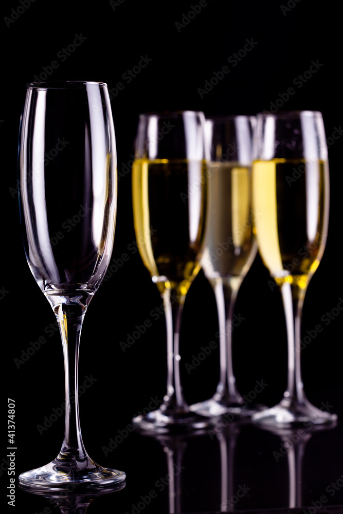 Three full glasses of champagne and one empty Three full glasses of champagne and one empty