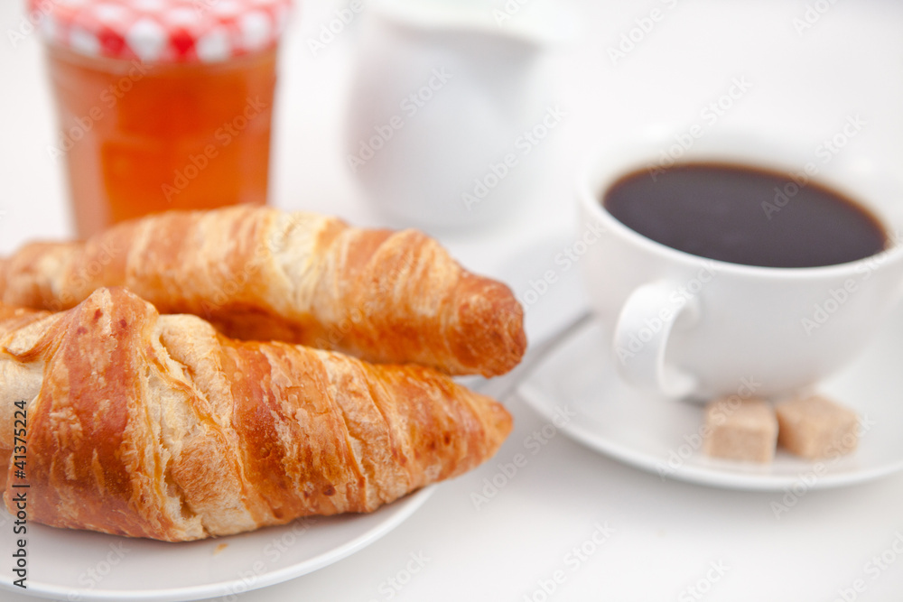 Croissants and a cup of coffee on white plates with sugar milk a Croissants and a cup of coffee on white plates with sugar milk a