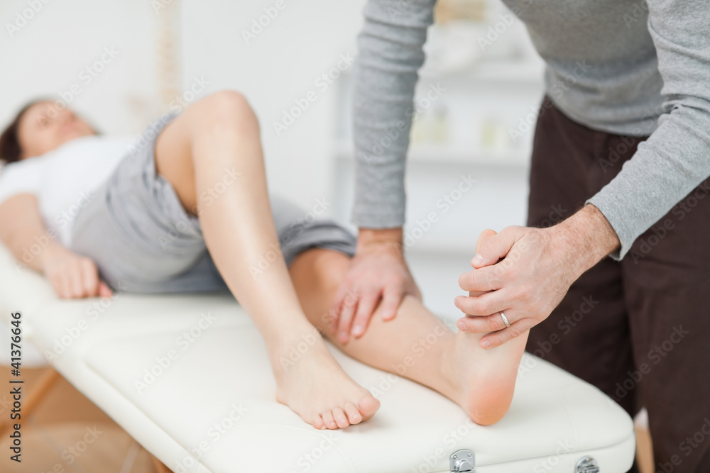 Fototapeta premium Physiotherapist stretching a barefoot