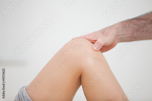 Close-up of a physiotherapist touching a knee
