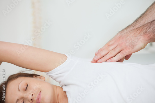 Peaceful patient being massaged by a doctor