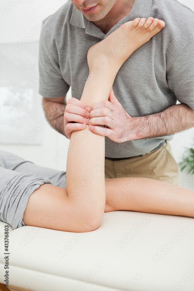 Close-up of a man massaging the leg of a woman Close-up of a man massaging the leg of a woman
