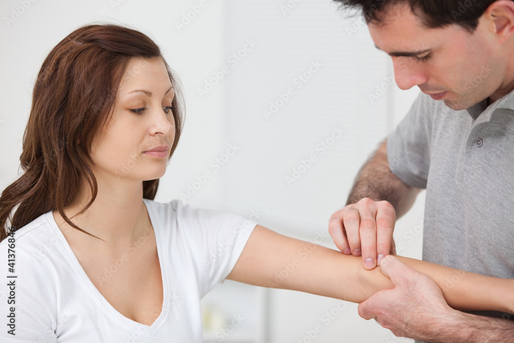 Doctor examining the arm of a patient Doctor examining the arm of a patient