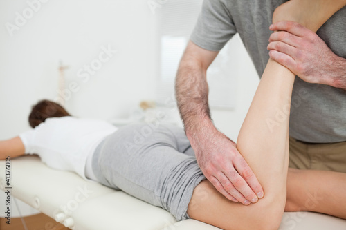 Woman lying while being massaged by a man